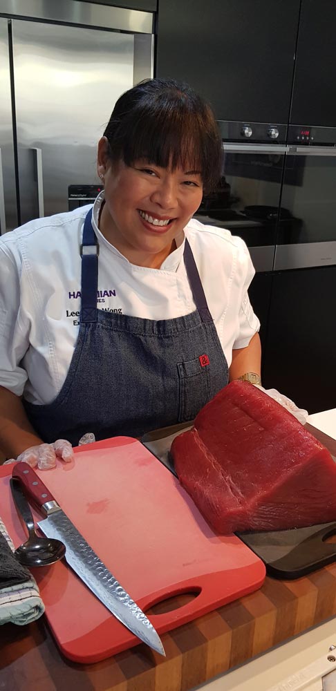 Hawaiian Airlines' Executive Chef Lee Anne Wong with a sizeable tuna steak