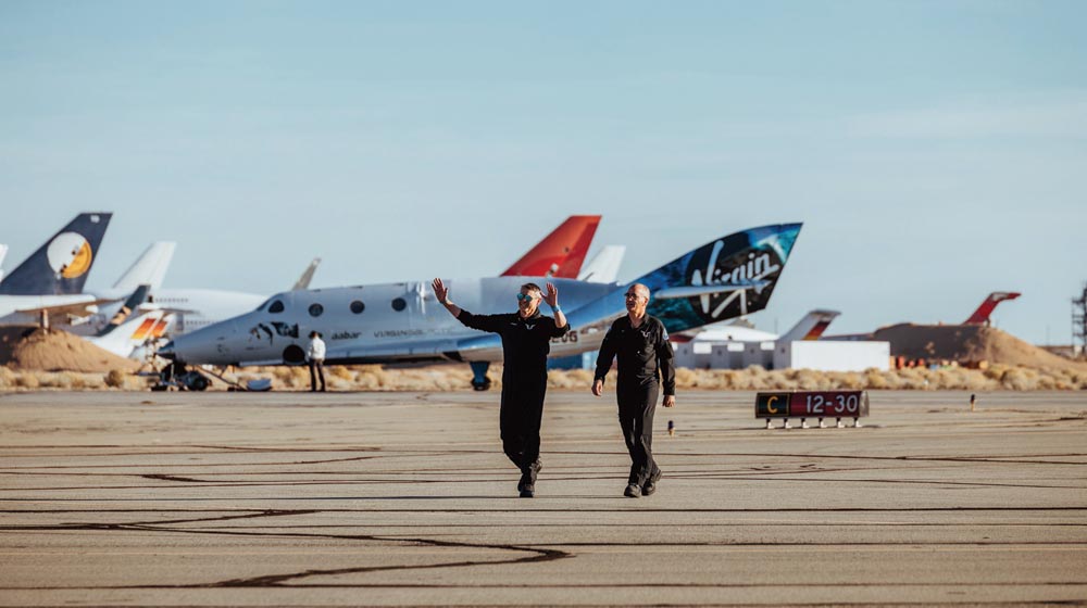 Virgin Galactic's first two astronauts walk back to greet Richard